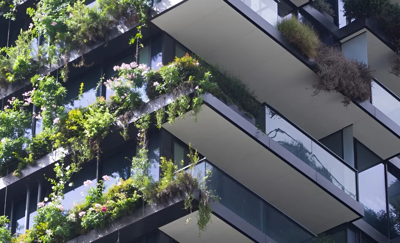 A modern concrete building overgrown with greens